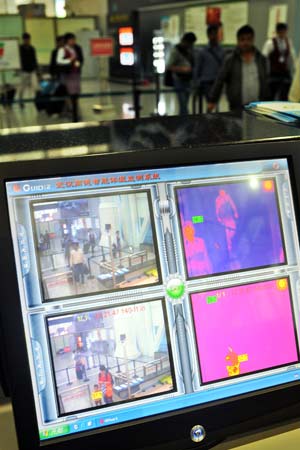 Infrared temperature measuring devices are used at Guangzhou Baiyun Airport on Wednesday as a preventive measure against the H7N9 bird flu virus. LIU DAWEI / XINHUA