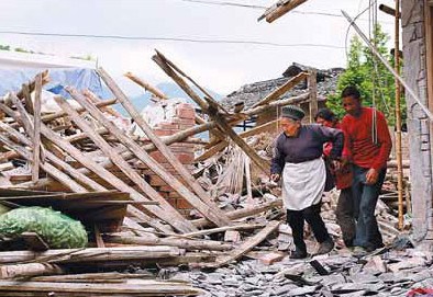 Villagers survey the remains of their houses in Wuxing.