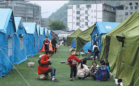 Displaced residents of Baoxing county in the tent city at the local stadium. Photos by Wang Jing / China Daily