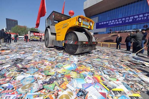 Pirated publications and CDs are destroyed in Taiyuan, capital of Shanxi province, on Thursday, to mark World Intellectual Property Day on Friday. Zhan Yan / Xinhua 