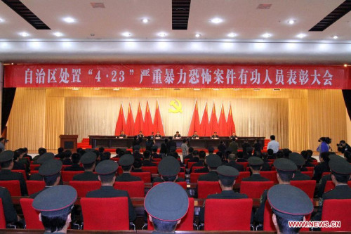 Photo taken on April 29, 2013 shows the scene of a commendation meeting held to award the 15 community workers and police officers who died during a terrorist clash on April 23 in Bachu County, Kashgar Prefecture, northwest China's Xinjiang Uygur Autonomous Region. The regional Communist Party of China (CPC) committee and government posthumously awarded the 15 individuals each as a regional anti-terrorist hero, seven of whom were also posthumously awarded as a regional outstanding CPC member. (Xinhua/Zhang Huawei)