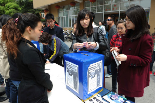 Students from Shanghai's Fudan University donate money to the parents of Huang Yang, who died from poisoning in April. A roommate has been charged with Huang's murder. [Photo by Lai Xinlin / for China Daily]