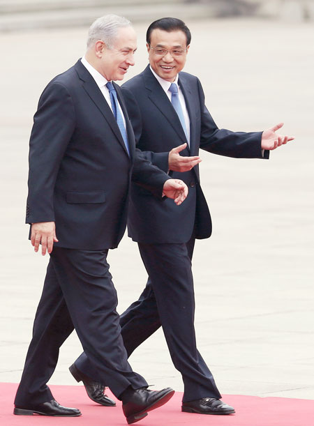 Premier Li Keqiang greets visiting Israeli Prime Minister Benjamin Netanyahu at the Great Hall of the People on Wednesday. Photo by Xu Jingxing / China Daily