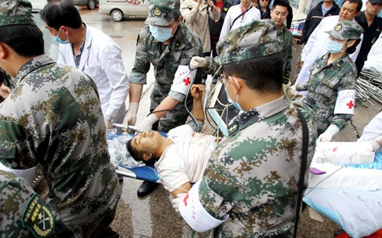 An injured man is taken to a hospital after a landslide in Lushan county, Sichuan province, on Thursday. The man was hurt when rocks from the landslide buried three vehicles carrying nine people, leaving three dead, local authorities said. The area was hit by a magnitude-7 earthquake on April 20. Zhu Xingxin / China Daily