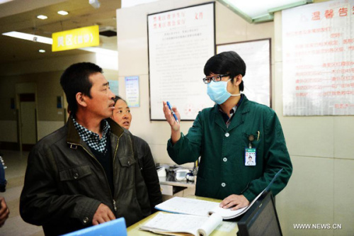 Teng Fei (R), a nurse of the 1st Affiliated Hospital of Harbin Medical University, guides relatives of a patient to clinic rooms in the hospital in Harbin, capital of northeast China's Heilongjiang Province, May 11, 2013. Male nurses in China are scarce, whose number accounts for merely one percentage of the total nurses in the country. Many people attribute the scarcity to society's view point that nursing is a women's job. Women are seen as more careful and patient than men, but, in general, male nurses are physically stronger or more energetic than women. They are particularly needed in Intensive Care Units, emergency departments, psychiatric hospitals and so on. (Xinhua/Wang Kai)