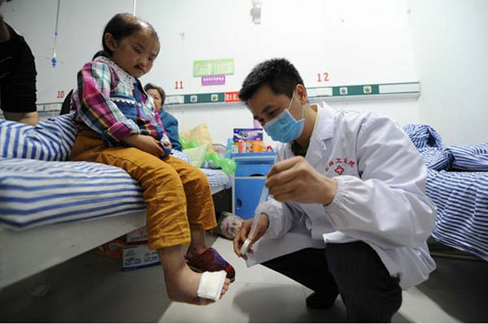 The girl, who police said was abused by her father, is treated at a clinic in a village in Jinsha county, Guizhou province, on Saturday. Her father has been detained. Provided to China Daily