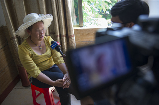 The mother of one of the girls during an interview. [Photo by Hai Nan / for China Daily]