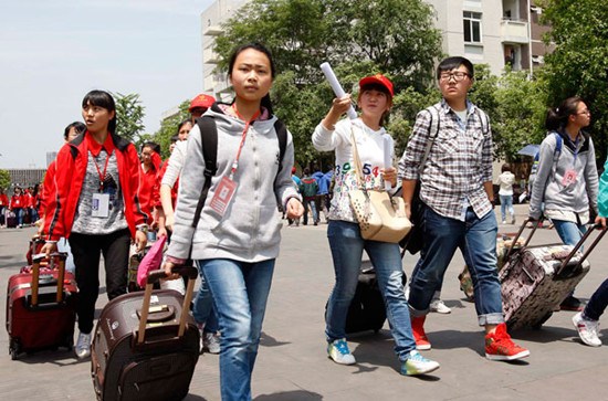 High school seniors from Tianquan county in Yaan, Sichuan, walk onto their new campus at Chengdu Normal University in Chengdu on April 24. The county's 1,019 students, affected by the magnitude-7 Lushan earthquake, will attend the national college entrance examination next month. Wang Ruobing / for China Daily