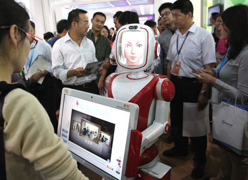 An intelligent robot that can interact with people attracts visitors to the expo. Photo by Zhang Wei / China Daily