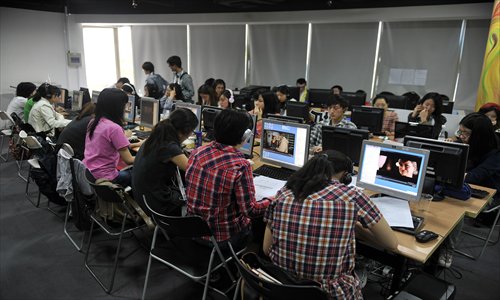 Student translators for the Shanghai International Film Festival work in an office in the Shanghai Television Station. Photo: Cai Xianmin/GT
