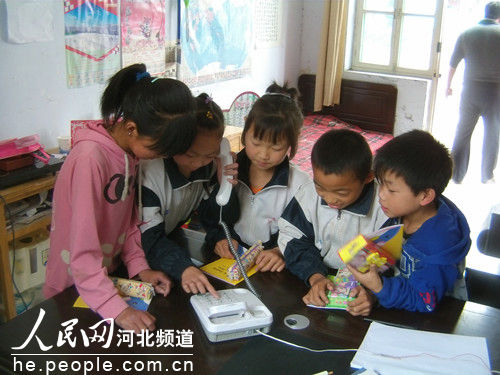 Left-behind children make phone calls to their parents in a primary school in Hebei Province. The Supreme People's Court has vowed zero tolerance of crimes that affect the rights of children, highlighting sexual abuse and corporal punishment.