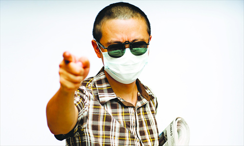 Featuring a mask and dark shades, Zhou Xiaoyun's signature look is a must for him when he attends public events. Photo: Courtesy of Zhou Xiaoyun