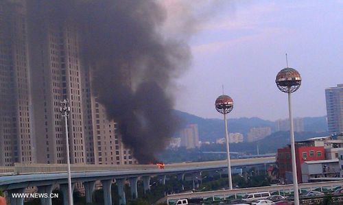A bus bursts into flames on an elevated track near the Jinshan bus stop in the city of Xiamen, southeast China's Fujian Province, June 7, 2013. (Xinhua/File Photo) 