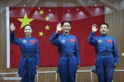 The three astronauts of the Shenzhou-10 manned spacecraft mission, Nie Haisheng (C), Zhang Xiaoguang (R) and Wang Yaping, meet the media at the Jiuquan Satellite Launch Center in Jiuquan, northwest China's Gansu Province, June 10, 2013. The Shenzhou-10 manned spacecraft will be launched at the Jiuquan Satellite Launch Center at 5:38 p.m. Beijing Time (0938 GMT) June 11. (Xinhua/Li Gang)