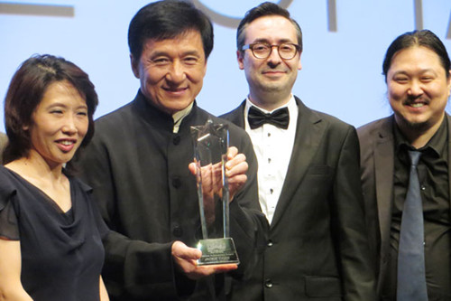 Representatives of the New York Asian Film Festival, the Film Society of Lincoln Center and the Hong Kong Economic and Trade Office in New York presented Hong Kong film star Jackie Chan with NYAFF's Star Asia Lifetime Achievement Award in New York on Monday. Caroline Berg / China Daily 