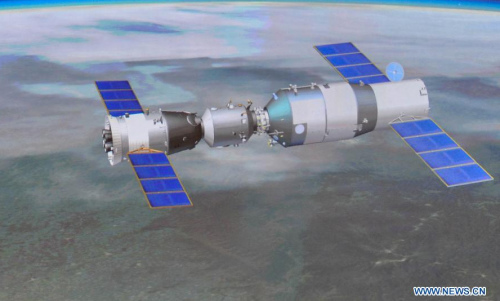 Photo taken on June 13, 2013 shows the screen at the Beijing Aerospace Control Center showing a simulated picture of an automated docking between the Shenzhou-10 manned spacecraft and the orbiting Tiangong-1 space module. China's Shenzhou-10 manned spacecraft successfully completed an automated docking with the orbiting Tiangong-1 space module at 1:18 p.m. Thursday. (Xinhua/Liu Chan) 