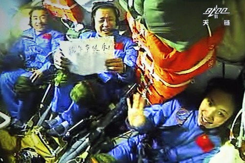Astronauts aboard Shenzhou X spacecraft, (from left) Zhang Xiaoguang, Nie Haisheng and Wang Yaping, send their festival regards. Wang Sijiang / For China Daily 
