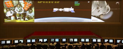 The giant screen in the Beijing Aerospace Command and Control Center broadcasts Shenzhou X spacecrafts robotic docking with the Tiangong-1 space module on Thursday. Photo by Sun Yang / For China Daily 
