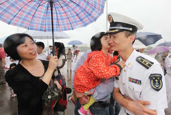 Wu Yu says goodbye to his wife and 3-year-old daughter before hospital ship Peace Ark leaves Zhoushan, Zhejiang province, for an aid tour to some Asian nations and the Gulf of Aden. ZHANG HAO / FOR CHINA DAILY 
