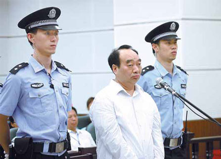 Lei Zhengfu, a former official of Chongqing's Beibei district, stands trial on Wednesday in a court in the city. He denied charges of taking bribes. Provided to China Daily 