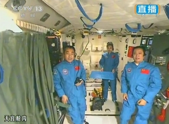This video grab shows China's three astronauts in the Tiangong-1 orbiter after the space lesson on June 20, 2013. (Photo: CNS)