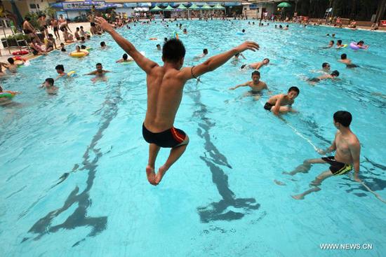 Citizens play in a pool in Suining City, southwest China's Sichuan Province, June 18, 2013. The highest temperature in many parts of China reached 37 degrees centigrade Wednesday. (Xinhua/Zhong Min)