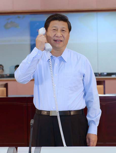 President Xi Jinping, at the Beijing Aerospace Control Center, talks on the phone with three astronauts in space module Tiangong-1 on Monday. Xi said the space mission is part of the dream to make China stronger. Photo / Xinhua 