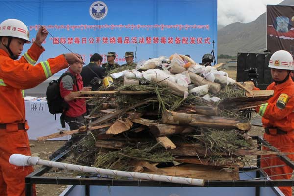 Police set fire to confiscated drugs in Lhasa, the Tibet autonomous region, on Wednesday, the International Day against Drug Abuse and Illicit Trafficking. Palden Nyima / China Daily 