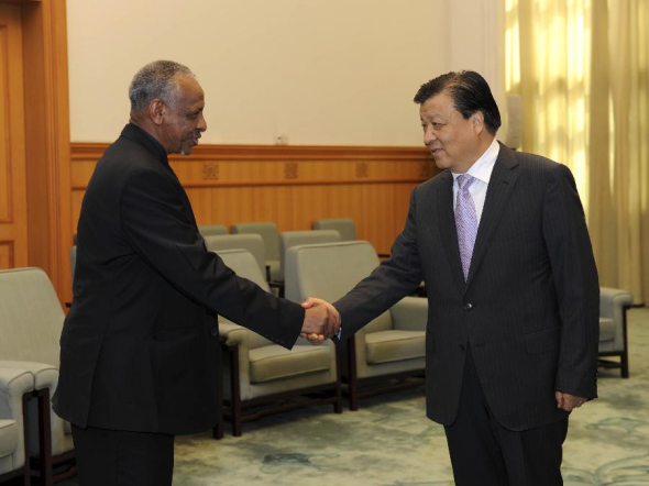 Liu Yunshan (R), a member of the Standing Committee of the Political Bureau of the Communist Party of China (CPC) Central Committee and member of the Secretariat of the CPC Central Committee, shakes hands with Nafie Ali Nafie, Sudanese presidential assistant and vice chairman of Sudan's ruling National Congress Party (NCP), who leads a delegation of senior Sudanese politicians, during their meeting in Beijing, capital of China, June 27, 2013. (Xinhua/Rao Aimin)