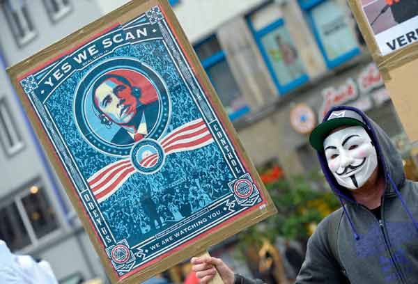 A demonstrator protests with a poster against espionage programs in Hanover, Germany, on Saturday. PETER STEFFEN / PICTURE-ALLIANCE / DPA VIA ASSOCIATED PRESS 