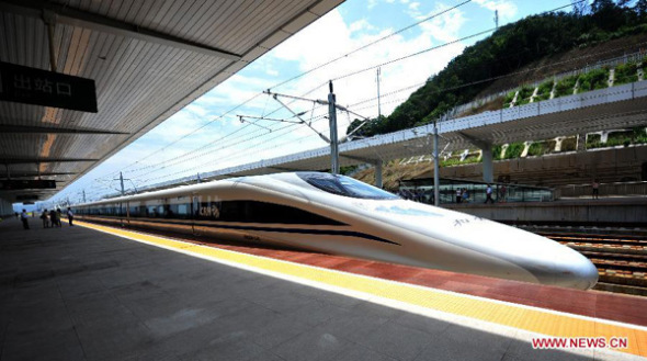 A bullet train traveling between Hangzhou and Nanjing enters Deqing Railway Station in east China's Zhejiang Province, July 1, 2013. The Nanjing-Hangzhou-Ningbo high-speed railway that stretches across east China's Yangtze River Delta was officially put into operation on July 1. The new high-speed railway is expected to boost the region's economy and foster the growth of tourism in the three cities it links (Xinhua/Wang Dingchang)