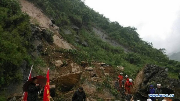 Rescuers search for survivors after a landslide in Gaoqiao Village of Yanjin County in Zhaotong City, southwest China's Yunnan Province, July 5, 2013. Nine people were buried by the landslide which happened on Friday morning. The rescue operation is underway. (Xinhua/Yuan Zhengxiong)