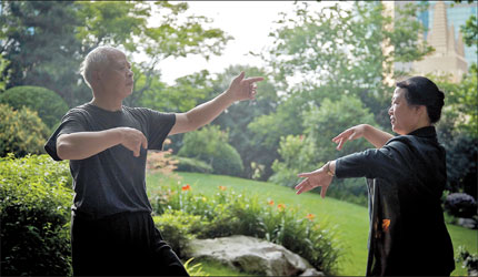 Two old people do morning exercise at a park in Jing'an District. Photo: Lan Hui