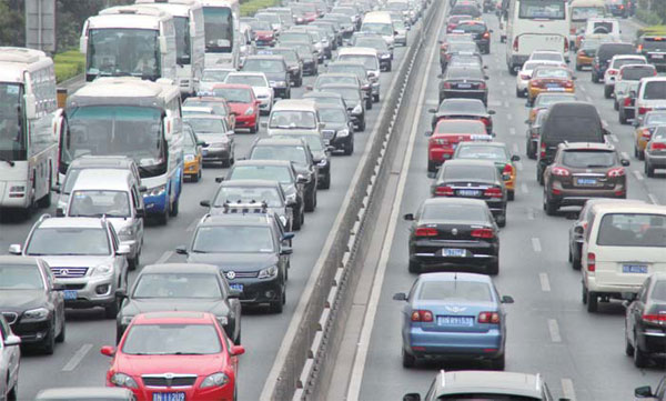 Cars crowd a highway in Beijing. Shijiazhuang plans to follow the capital's lead by restricting vehicle purchases. Wu Changqing / For China Daily