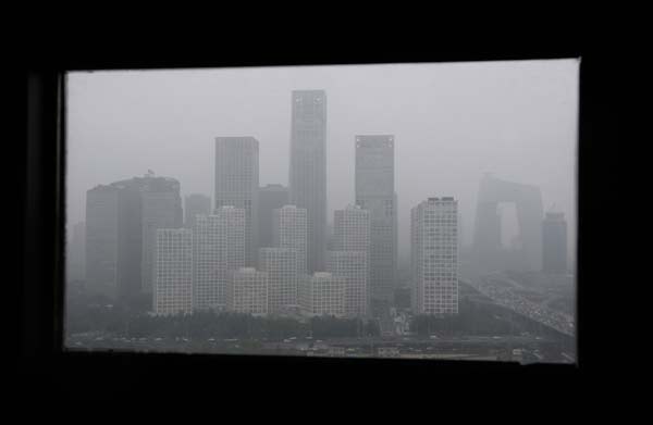 Buildings loom out of the haze in this view from a window in Beijing's Central Business District on Tuesday. Air pollution is shortening the lives of people in northern China by about 5.5 years, an international study shows. Jason Lee / Reuters 