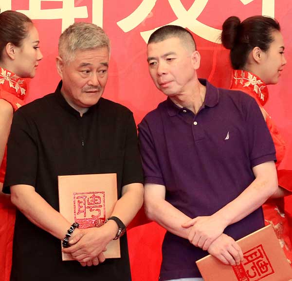 Film director Feng Xiaogang (right) and comedian Zhao Benshan chat at a ceremony in Beijing on Friday to accept China Central Television's invitation to direct the 2014 Spring Festival Gala. JIANG DONG / CHINA DAILY