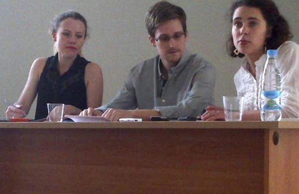 Former intelligence agency contractor Edward Snowden (C) and Sarah Harrison (L) of WikiLeaks speak to human rights representatives in Moscow's Sheremetyevo airport July 12, 2013. [Photo/Agencies]