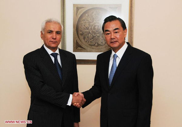 Chinese Foreign Minister Wang Yi (R) meets with Tajikistan's Foreign Minister Hamrokhon Zarifi as they attend a meeting of the Council of Foreign Ministers of the Shanghai Cooperation Organization (SCO) in Cholpon-Ata, Kyrgyzstan, July 13, 2013.(Xinhua/Guan Jianwu)