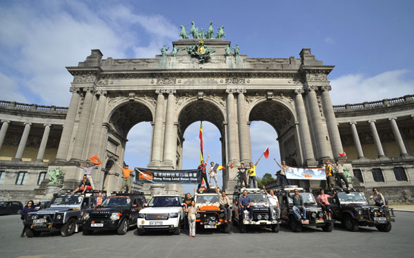 A group of Land Rover fans from Hong Kong cheer before Parc du Cinquantenaire in Brussels over the weekend to celebrate completing one-third journey of their expedition in sixteen countries. [Photo/Provided for China Daily]