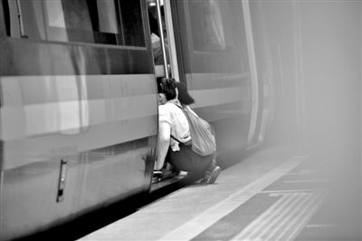 Photo released by The Beijing News shows a child beggar entering the metro.