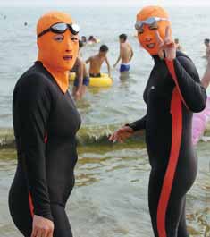 Two women wear facekinis at a beach in Qingdao. Huang Jiexian / for China Daily