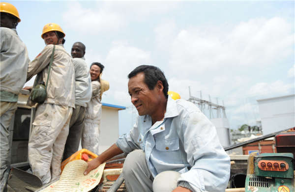 Chinese and African men, employed by Sinohydro, a Chinese State-owned hydropower engineering and construction company, return to their dormitories at the end of the working day in the port city of Bata, Equatorial Guinea. Abdelhak Senna/AFP