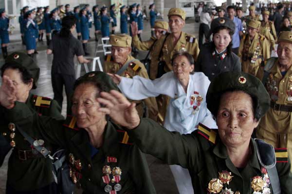Veterans of the Korean War (1950-53) from across the Democratic People��s Republic of Korea arrive in Pyongyang on Tuesday as the country prepares to mark the 60th anniversary of the end of the war, on Saturday. PHOTO BY JON CHOI-JIN / ASSOCIATED PRESS