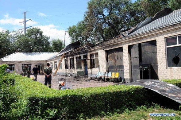 Photo taken on July 26, 2013 shows the accident site at the Lianhe Senior Nursing Home where a fire took place in Hailun City, northeast China's Heilongjiang Province. Eleven people were killed in the fire that occurred early Friday. A total of 283 elderly people were living in the nursing home, which was built in October 2005. With an area of 7,000 square meters, it caters for the rural elderly in the city who have no source of income. (Xinhua/Wang Song)