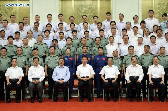 China's top leaders Xi Jinping (C front), Li Keqiang (3rd R front), Zhang Dejiang (3rd L front), Yu Zhengsheng (2nd R front), Liu Yunshan (2nd L front), Wang Qishan (1st R front) and Zhang Gaoli (1st L front) meet with astronauts and scientists who participated in the Shenzhou-10 mission, at the Great Hall of the People in Beijing, capital of China, July 26, 2013. (Xinhua/Lan Hongguang)