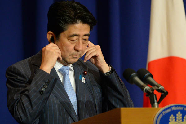 Japanese Prime Minister Shinzo Abe pledges continued support for Philippine maritime forces in Manila on Saturday. [TED ALJIBE / Agence France-Presse]