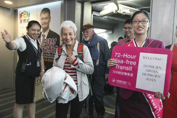 Joan Hepburn and her husband Brian, from New Zealand, become the first foreigners landing at Guangzhou Baiyun International Airport to benefit from the city's 72-hour visa-free policy on Thursday. The Guangdong provincial capital has joined Beijing and Shanghai in offering three-day visa-free stays to transit passengers. PHOTO BY LU HANXIN / XINHUA