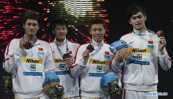 (L-R) Li Yunqi, Wang Shun, Hao Yun and Sun Yang of Team China show their bronze medals during the awarding ceremony for the men's 4x200m freestyle final of the swimming competition of the 15th FINA World Championships at Palau Sant Jordi in Barcelona, Spain on Aug. 2, 2013. Team China took the bronze medal with 7:04.74. (Xinhua/Xie Haining)