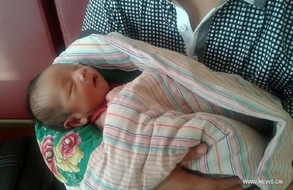 Photo taken on Aug. 4, 2013 shows a baby rescued by police from an infant trafficking in central China's Henan Province. On July 17, a gynecologist surnamed Zhang from Fuping County Maternal and Child Health Care Hospital in northwest China's Shaanxi Province, allegedly sold the newborn to a man and woman from neighboring Shanxi Province, surnamed Pan and Cui, for 21,600 yuan (3,494 U.S. dollars), according to the county's public security bureau. Police found that Zhang lied to the mother of the baby born on July 16, telling the mother that her child had a congenital infectious disease and disability, then the gynecologist tricked the mother into letting her handle the baby. By far, Zhang, Pan and Cui have all been detained by police. (Xinhua)