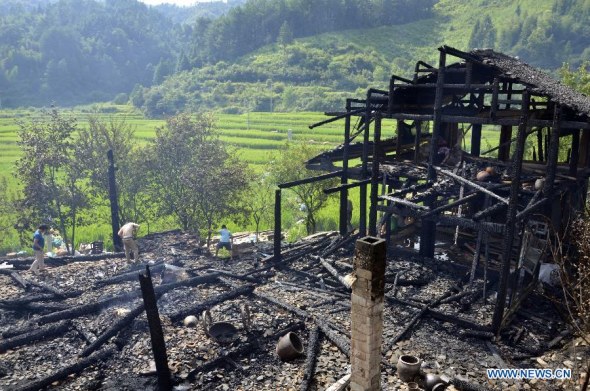 Houses are damaged in a fire at the Jiangkou Village of Jingzhou Miao and Dong Autonomous County, central China's Hunan Province, Aug. 5, 2013. No casualties were reported, but houses of 248 villagers were damaged in the fire. (Xinhua/Liu Jiehua)